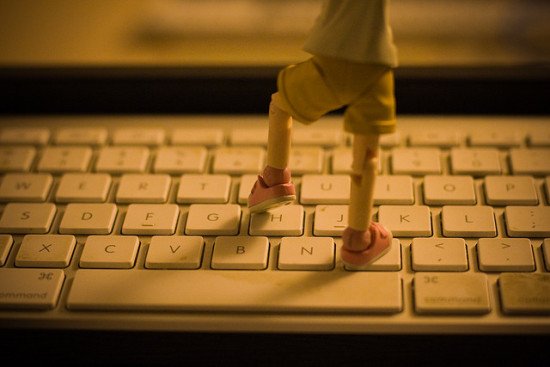 A small figurine stepping on a keyboard by KayVee.INC, via Flickr