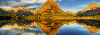 Mountains at the Glacier National Park reflected perfectly in a lake