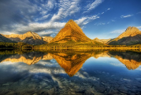 Mountains at the Glacier National Park reflected perfectly in a lake
