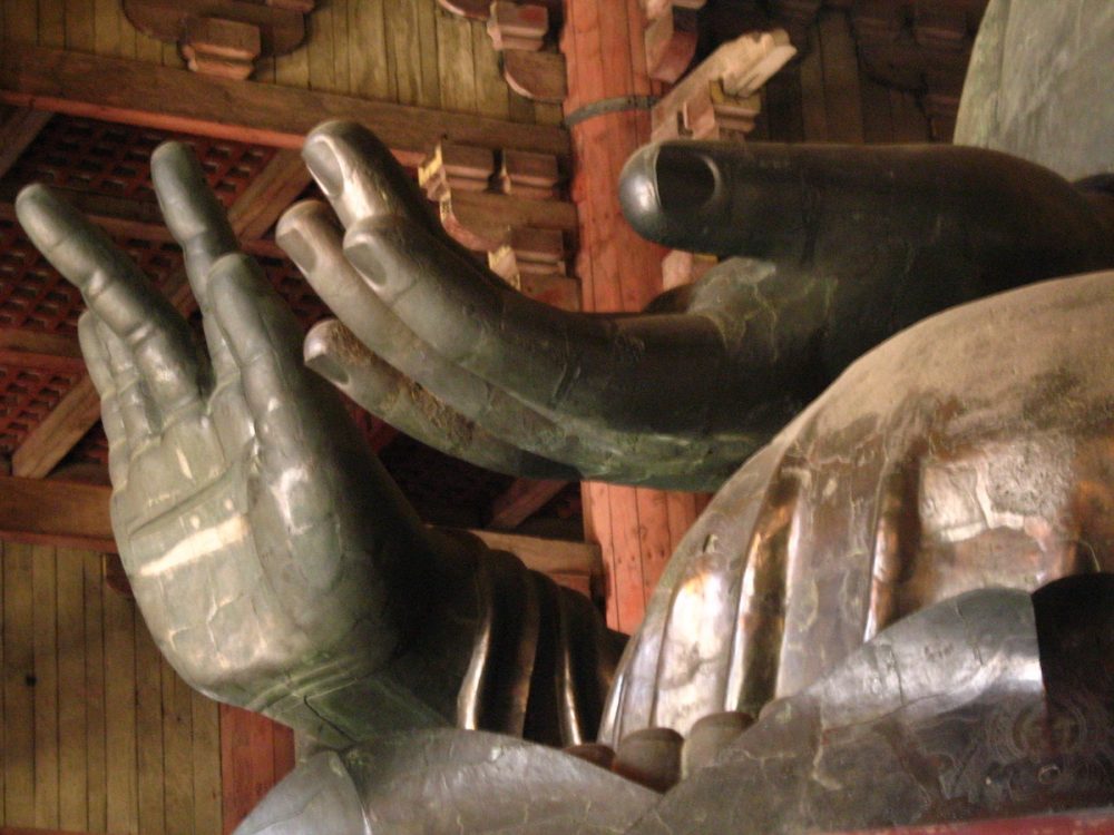 Image: hands of a large Buddha statue