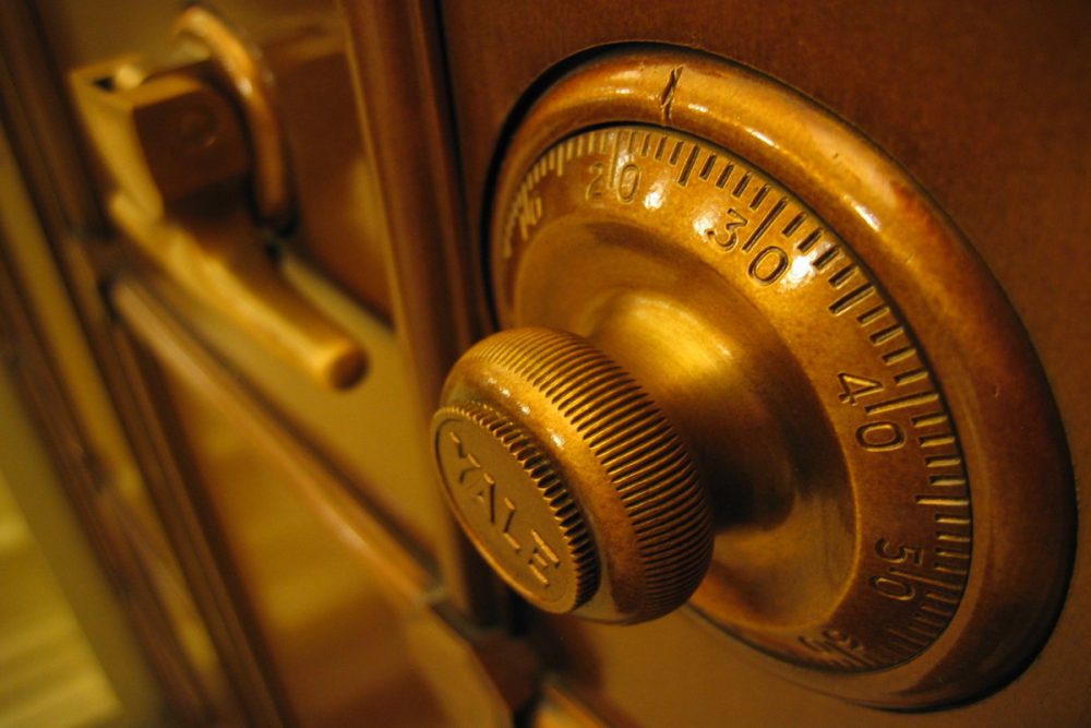 Image: the rotary lock dial and handle of a large safe.