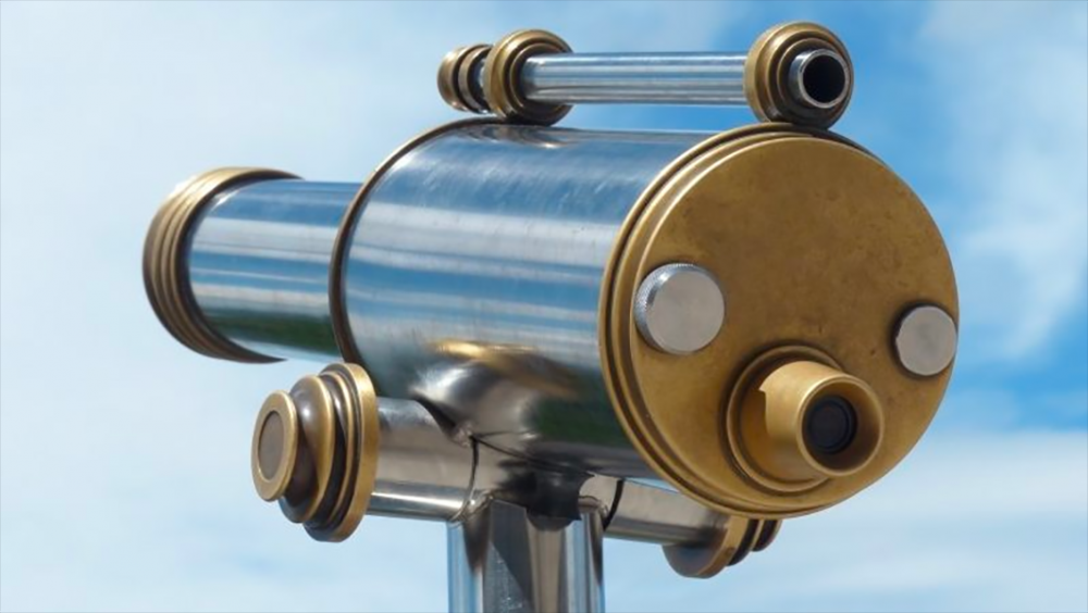 Image: chrome and gold colored telescope viewer at a scenic overlook.