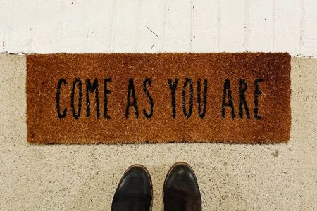 Image: a doormat with the words "Come as you are" on it.