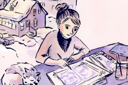 Image: an illustration by K. Woodman-Maynard of herself seated at her desk, painting spreads of her graphic novel, with her cat curled asleep beside her.