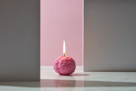 Image: a flame burns atop a small, brain-shaped candle.