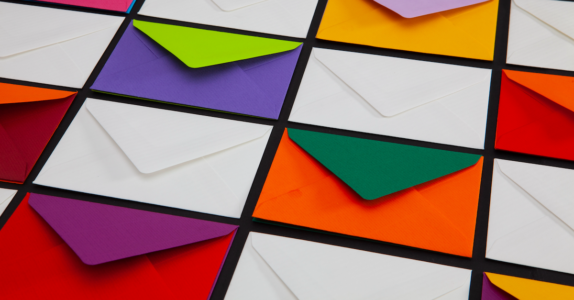 Image: colorful envelopes arranged in a grid, with their flaps open.