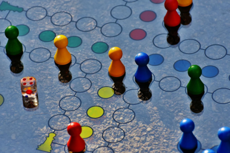 Image: A board game on which the gameplay has pieces moving from one circle to another in continuous fashion.