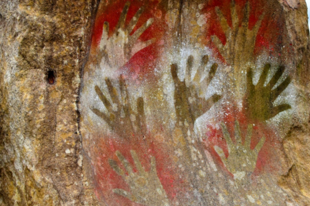 Image: ancient hand paintings on a cave wall