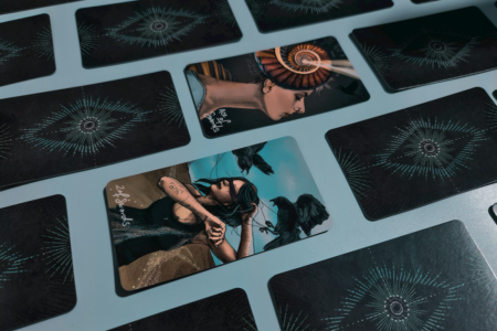 Image: tarot cards arranged face down in straight rows, except for the Ace of Swords and 2 of Swords which are turned face up.