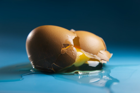 Image: a broken egg spills its contents.