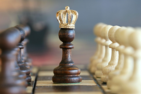 Image: a chess pawn wearing a crown