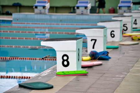 Image: competitive lanes and diving platforms are marked on swimming pool.