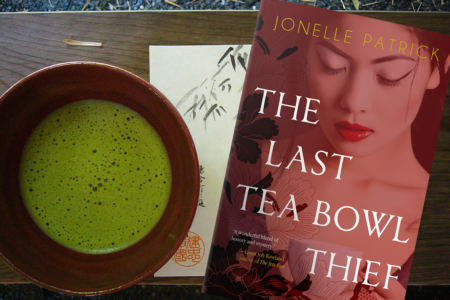 Image: photo of Jonelle Patrick's book The Last Tea Bowl Thief alongside a bowl of matcha tea.